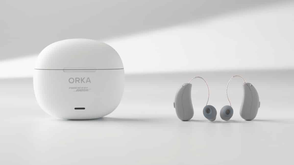 Two ORKA O1 RIC hearing aids with white charging case