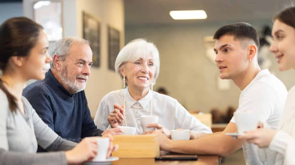 Older Couple In Conversation Group