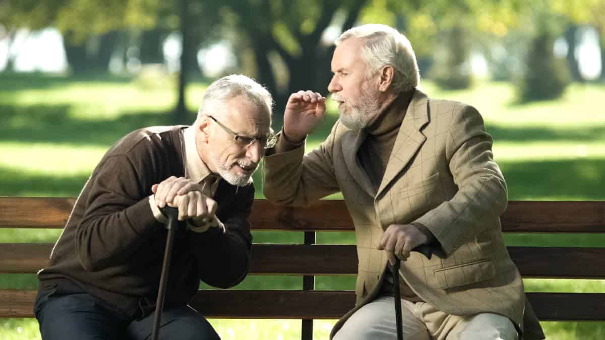 Senior Men On Parkbench Hearing Loss